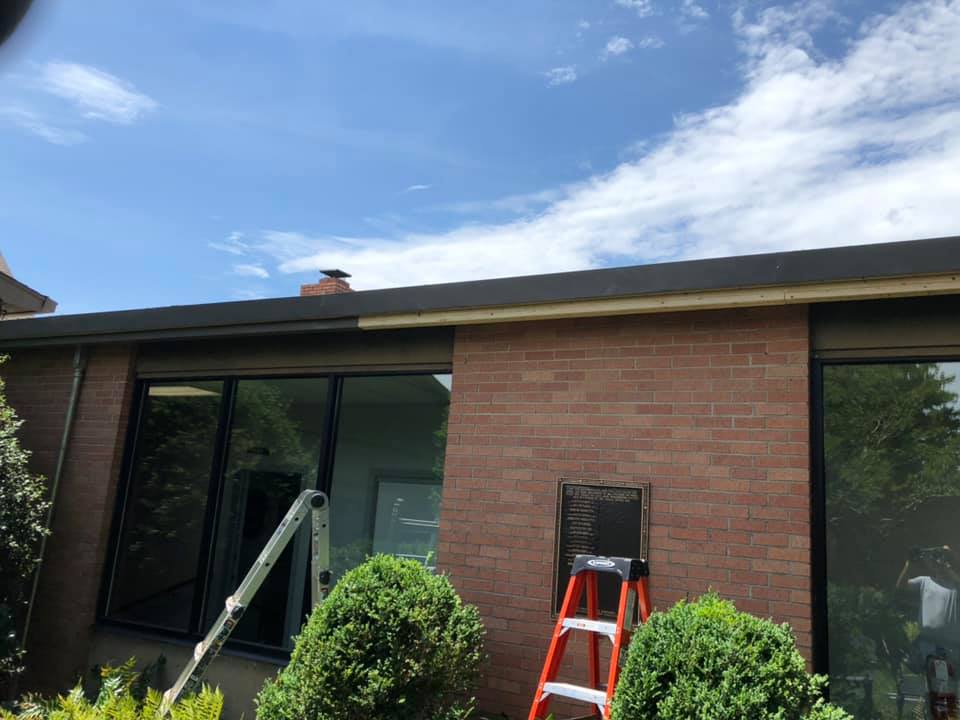 Legacy Gutter Co. crew installing seamless gutters